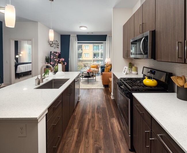 Counters run both walls, with the living room framed at the end of the run. - 675 N. Highland