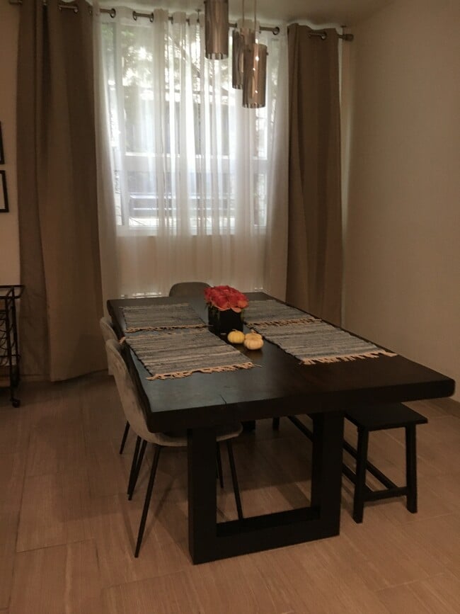 Dining Room with floor to ceiling curtains. Table and chairs are not included in lease. - 10315 Missouri Ave
