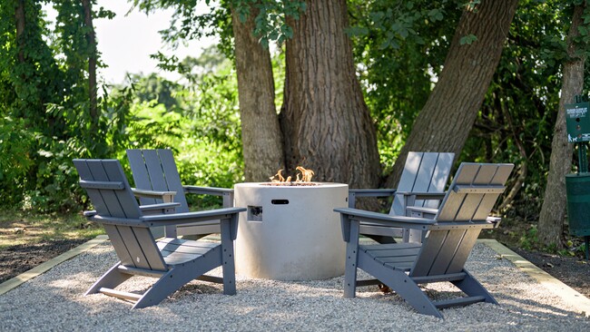 Discover relaxation by our community fire pit, where the glow of the flame adds an extra layer of charm. - The Willows