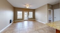 Located at 3455 Trail Head Dr in Paducah, Kentucky, this single-floor, 2-bedroom, 2-bathroom home offers a practical and comfortable layout. The kitchen is a standout feature, boasting warm honey-toned cabinetry, granite countertops, a white subway tile backsplash, and a full suite of stainless steel appliances including a refrigerator, range, microwave, and dishwasher. Large tile flooring runs throughout the kitchen and living areas, lending a clean, cohesive look. The living and dining area is bright and open, featuring tile flooring, a ceiling fan, and multiple windows alongside a glass door that fills the space with natural light and provides outdoor access. Both bedrooms are well-sized, carpeted for comfort, and equipped with ceiling fans and windows that bring in natural light. The primary bedroom connects conveniently to one of the bathrooms. Each bathroom features warm wood-toned vanities and tile flooring; one includes a tub-shower combination with a large mirror and ample counter space, while the second is neatly appointed with a vanity and bathtub. A dedicated closet adds practical storage to the home. The warm, neutral color palette throughout creates a cohesive and inviting atmosphere.