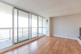 Located at 200 Bay St S in Hamilton, Ontario, this two-bedroom, one-bathroom unit offers a well-organized layout across a single floor. Warm hardwood flooring flows throughout the main living areas and bedrooms, complemented by neutral-toned walls and textured ceilings that add character to the space.

The living area is a standout feature, showcasing expansive floor-to-ceiling windows and access to a balcony that frames elevated views of the Hamilton cityscape, filling the room with abundant natural light. The primary bedroom is a comfortable size, also benefiting from large windows with sweeping city views, while the second bedroom provides additional flexibility for guests or a home office.

The kitchen is thoughtfully appointed with warm wood cabinetry, granite countertops, a classic white subway tile backsplash, a double stainless steel sink, and tile flooring — offering both functionality and style. A dedicated hallway connects the rooms and provides access to the full bathroom, which features matching granite countertop vanity, tile flooring, and a full soaker tub-shower combination enclosed by crisp white subway tile.

The unit's layout is efficient and practical, making excellent use of its footprint to deliver a comfortable living experience in the heart of Hamilton's urban core.