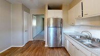 Located at 300 Pat Mell Rd in Marietta, Georgia, this one-bedroom, one-bathroom unit offers a practical and well-organized single-floor layout. The kitchen is a functional galley-style space featuring stainless steel appliances, including a gas range and full-size refrigerator, white cabinetry with ample storage, a classic subway tile backsplash, granite-look countertops with a double sink, and durable wood-look flooring. A hallway connects the kitchen to the rest of the unit, providing a clear and efficient flow throughout.

The living room is a generously sized, carpet-floored space bathed in natural light through large windows dressed with vertical blinds, creating a bright and open atmosphere. The spacious primary bedroom continues the same soft carpet flooring and is equipped with a ceiling fan with light fixture, a large window for natural light, and the notable convenience of two separate closets for plentiful storage. An additional third closet is available elsewhere in the unit.

The bathroom features a full tub-shower combination with a handheld showerhead, tile surround in a warm neutral tone, and a small window for natural ventilation. A dedicated utility room rounds out the layout, adding everyday practicality to this well-appointed Marietta residence.