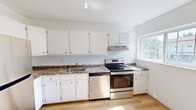 Located at 50 Rinaldi in Poughkeepsie, NY, this two-floor residence offers a practical and well-organized layout across three bedrooms, a kitchen, a hallway, a closet, and a staircase connecting the levels. The majority of the living space is situated on the upper floor, with a smaller entry area on the lower level.

The kitchen is bright and clean, featuring white cabinetry that extends to the upper walls for ample storage, granite-style countertops, a stainless steel range with overhead ventilation, and a double-basin sink. Light hardwood flooring and a window admitting natural light give the kitchen an open, airy feel.

The bedrooms are carpeted throughout and finished in neutral white tones, creating a calm and versatile living environment. The generously sized primary bedroom includes a large window with outdoor views and direct access to a dedicated closet. Additional bedrooms are well-proportioned, each with baseboard heating and windows that bring in natural light. One bedroom features hardwood-style flooring, adding variety to the interior finishes.

Storage is thoughtfully included, with a built-in closet featuring shelving and hanging rods, as well as an additional angled storage space under the roofline. The layout connects efficiently through a central hallway, making the overall flow of the residence practical and easy to navigate.