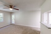 Located at 1159 Harrison Pike in Cleveland, Tennessee, this single-floor, one-bedroom, one-bathroom home offers a well-organized and functional layout. The living room features neutral-toned carpet, a ceiling fan with light fixture, a textured ceiling, and a door providing direct access to a private patio with outdoor views — allowing natural light to fill the space. The kitchen is thoughtfully updated with crisp white shaker cabinets, granite-look countertops, a subway tile backsplash, and wood-look vinyl plank flooring. It is equipped with stainless steel appliances including a dishwasher and electric range, as well as a black refrigerator. A skylight adds additional brightness to the kitchen area. The generously sized bedroom is carpeted and features a window with natural light, a textured ceiling, and a door connecting to the bathroom for added convenience. The full bathroom includes a tub-shower combo with a curved curtain rod. The home also includes two closets — one of which is a walk-in with wire shelving — as well as a dedicated laundry area. Clean, neutral finishes throughout create a cohesive and move-in ready atmosphere.