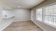 This 490 square foot apartment in North Charleston offers a thoughtfully designed living space. The single-floor layout includes a living room, one bedroom, and one bathroom. The primary bedroom, measuring 170 square feet, provides ample space for rest and relaxation.

Throughout the apartment, warm-toned wood-look flooring creates a cohesive and inviting atmosphere. The neutral walls in a light beige hue contribute to a bright, airy feel. Large windows in the living area and bedroom allow natural light to flood the space, enhancing the sense of openness.

The living room features a ceiling fan for improved air circulation and comfort. Built-in closets with louvered doors in the bedroom offer generous storage solutions. A notable addition is a wall-mounted shelf, providing extra storage or display space.

The bathroom, while compact, is efficiently designed with a combined tub and shower, and features clean white fixtures. The kitchen, though not pictured in detail, appears to be integrated into the open plan living area, maximizing the use of space.

This apartment at 6601 Dorchester Rd combines modern conveniences with a practical layout, making it an ideal choice for those seeking a low-maintenance yet comfortable living environment in North Charleston.