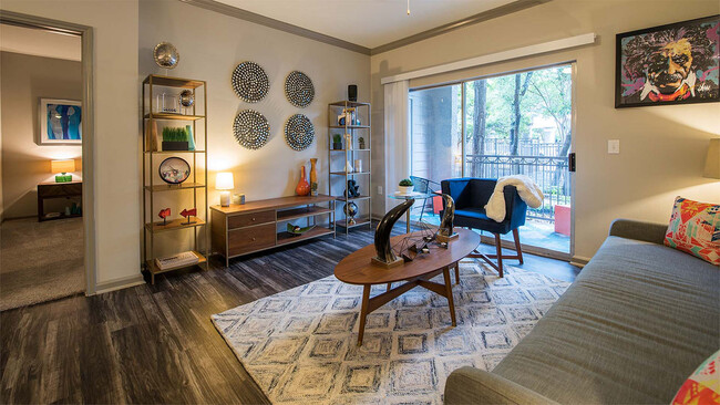 Apartment Living Room with wood floors. - Griffis Lakeline Station