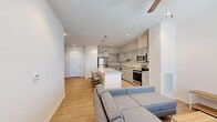 Located in Pullman, WA, this two-story residence offers four bedrooms and five bathrooms across two well-proportioned floors. The main level centers on an open-concept living and kitchen area, where light hardwood-style flooring flows throughout. The kitchen is outfitted with stainless steel appliances, including a refrigerator, range, microwave, and dishwasher, complemented by gray shaker-style cabinetry and granite countertops. A large central island with seating for multiple bar stools serves as both a prep space and casual dining area, illuminated by pendant lighting above. The adjoining living room receives generous natural light through large windows fitted with horizontal blinds, and includes a ceiling fan overhead.

The bathrooms feature consistent finishes throughout, including granite-topped vanities with gray cabinetry, tub-shower combinations, and wood-look flooring. Bedrooms are carpeted and include ceiling fans, with windows providing natural light and views of the surroundings. Each bedroom offers functional space suitable for a bed, desk, and storage. Two hallways and two closets contribute to the overall functionality of the layout, ensuring practical circulation across both floors.
