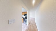 This 1040 square foot apartment offers a practical and comfortable living space with three bedrooms and two bathrooms. The kitchen is a highlight, featuring oak cabinetry, stainless steel appliances, and a subway tile backsplash. The spacious layout includes a separate laundry room with full-sized washer and dryer units, ensuring convenience for residents.

The bedrooms are generously sized, with the primary bedroom measuring 180 square feet. Each bedroom is carpeted and includes a closet for storage. The bathrooms are well-appointed, featuring tile flooring, modern fixtures, and a combination of shower/tub units.

Throughout the apartment, neutral tones dominate, creating a blank canvas for personal decor. The living areas benefit from natural light through windows with blinds. The apartment's design emphasizes functionality, with two hallways and three closets providing additional storage options.

Located in the Summit West complex, unit 2D-C2 offers a practical and comfortable living environment. The single-floor layout and modern amenities make this apartment an attractive option for those seeking a well-designed living space.