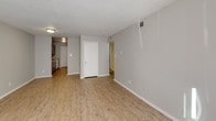 Located at 1102 W Poinsett St in Greer, South Carolina, this single-floor home offers a practical and well-maintained layout with a clean, neutral aesthetic throughout. The open living area welcomes you with light wood-style flooring, soft gray walls, and a textured ceiling, creating a bright and inviting atmosphere. Natural light filters in through windows, adding warmth to the space.

The galley-style kitchen is efficiently designed, featuring gray cabinetry, granite-look countertops, a double-basin stainless steel sink, and white appliances including a range and refrigerator. A door at the end of the kitchen provides convenient access, and the light wood flooring continues seamlessly from the living areas.

The bedrooms are finished with plush carpeting and neutral-toned walls, providing a comfortable and quiet retreat. Each room benefits from natural light through windows with blinds.

The bathroom is appointed with a full tub and shower combo surrounded by white tile, a toilet, and a vanity with under-sink storage, a wall mirror, and overhead lighting. Tan floor tiles tie the space together with a clean, functional finish.

Overall, this home presents a straightforward and move-in ready interior with consistent finishes, making it a practical choice in the Greer, SC community.