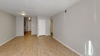 Located at 1102 W Poinsett St in Greer, South Carolina, this single-floor home offers a practical and well-maintained layout with a clean, neutral aesthetic throughout. The open living area welcomes you with light wood-style flooring, soft gray walls, and a textured ceiling, creating a bright and inviting atmosphere. Natural light filters in through windows, adding warmth to the space.

The galley-style kitchen is efficiently designed, featuring gray cabinetry, granite-look countertops, a double-basin stainless steel sink, and white appliances including a range and refrigerator. A door at the end of the kitchen provides convenient access, and the light wood flooring continues seamlessly from the living areas.

The bedrooms are finished with plush carpeting and neutral-toned walls, providing a comfortable and quiet retreat. Each room benefits from natural light through windows with blinds.

The bathroom is appointed with a full tub and shower combo surrounded by white tile, a toilet, and a vanity with under-sink storage, a wall mirror, and overhead lighting. Tan floor tiles tie the space together with a clean, functional finish.

Overall, this home presents a straightforward and move-in ready interior with consistent finishes, making it a practical choice in the Greer, SC community.