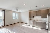 Located at 900 E Main St in Chattanooga, TN, this well-designed one-bedroom, one-bathroom unit offers a clean, modern aesthetic across a single floor. The open-concept layout seamlessly connects the living room, dining area, and kitchen, creating a bright and functional shared space. Light streams in through window blinds onto light-toned hardwood-style flooring, which flows consistently throughout the unit, lending a cohesive and airy feel. A ceiling fan with recessed lighting keeps the living area comfortable and well-lit.

The kitchen is a standout feature, outfitted with taupe flat-front cabinetry, granite-style countertops, and a full suite of stainless steel appliances including a refrigerator, electric range, microwave, and dishwasher. The layout offers ample counter space and storage for efficient everyday use.

The bedroom is a calm, neutral retreat with a window offering natural light and views of the surrounding cityscape. It is complemented by a dedicated closet and convenient access to the full bathroom, which features a granite-topped vanity with dark cabinetry and a shower-tub combination. In-unit laundry adds a practical finishing touch to this thoughtfully appointed Chattanooga residence.