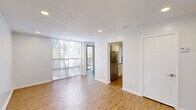 Located at 1000 Crystal Lake Cir in Macon, Georgia, this 2-bedroom, 1-bathroom home offers a thoughtfully laid-out single-floor design that maximizes every square foot. The living room is bright and open, featuring warm wood-look flooring, recessed lighting, and a large floor-to-ceiling window that floods the space with natural light and offers views of the surrounding trees. The adjacent dining room flows seamlessly into the kitchen, which is a standout feature of the home. It is equipped with white shaker-style cabinetry, granite countertops, a stainless steel range and refrigerator, and a striking mosaic tile backsplash that adds a modern touch. Both bedrooms are well-proportioned and carpeted for comfort, with recessed lighting and large windows that invite natural light. The primary bedroom includes a double-door closet, providing ample storage. The bathroom is clean and functional, featuring a full bathtub with shower and wood-look flooring that ties in with the rest of the home. Crown molding is present throughout, adding a refined finish to the overall aesthetic. This home combines practical design with updated finishes in a well-connected Macon location.