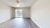 Located at 829 NW 79th Ter in Kansas City, MO, this well-appointed one-bedroom, one-bathroom residence offers a functional and comfortable single-floor layout. The open-concept living and dining area features durable hardwood-style flooring, neutral wall tones, and a ceiling fan with light fixture, creating a bright and airy atmosphere. A sliding glass door leads to a private balcony, bringing in natural light and offering views of the surrounding community. The kitchen is thoughtfully designed with a pass-through breakfast bar that opens to the living space, white cabinetry, a stainless steel refrigerator, and a gas range, making it ideal for everyday cooking and casual entertaining. A hallway connects the main living area to the private bedroom, which is generously sized and finished with plush carpet, a ceiling fan, and a dedicated closet offering ample storage. The bathroom features a full-size tub and shower combo with clean white surrounds. Textured ceilings throughout add a classic residential character, while the neutral color palette and consistent finishes create a cohesive and move-in-ready feel across the entire space.