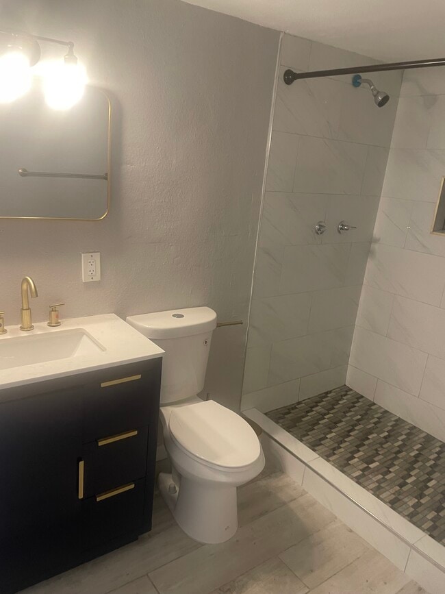 New bathroom with gold finishes - 2302 E Yale St