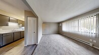 Located at 2704 Westmar Ct in Toledo, Ohio, this single-floor, 2-bedroom, 1-bathroom unit offers a practical and functional layout. The living room is a comfortable, carpeted space bathed in natural light through large windows dressed with vertical blinds. A wall-mounted air conditioning unit and baseboard heating ensure year-round comfort. The galley-style kitchen features dark cabinetry with ample overhead storage, a double-basin sink, light countertops, and a white electric range, all set atop wood-look flooring. The spacious primary bedroom is generously sized and includes two louvered bi-fold closet doors, providing abundant storage. The second bedroom also features plush carpeting, a window with natural light, and baseboard heating. Both bedrooms are finished in neutral, warm-toned paint. The full bathroom includes a tub/shower combination with a clean, white surround. Throughout the unit, four closets offer exceptional storage capacity. The space maintains a neutral, understated aesthetic with textured ceilings, clean white trim, and a consistent warm-gray color palette, creating a calm and move-in-ready environment.