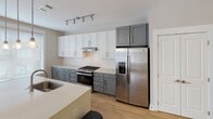 Located at 5820 Market Way Dr in Charlotte, NC, this single-floor residence offers a thoughtfully designed layout with modern finishes throughout. The interior is unified by light wood-look flooring in the main living and kitchen areas, transitioning to plush carpeting in the bedrooms.

The kitchen serves as a central highlight, showcasing two-tone cabinetry with white upper cabinets and gray lower cabinets, a white quartz island with an undermount sink, subway tile backsplash, stainless steel appliances including a gas range and side-by-side refrigerator, and pendant lighting complemented by track lighting. Large windows flood the space with natural light.

An elegant arched entryway connects the main living area to the kitchen. A bonus room features built-in shelving and hardwood-style flooring, offering flexible use as an office or media space.

The bedrooms are comfortably sized, each featuring ceiling fans and windows with blinds. The primary bathroom includes a dual-sink vanity with dark quartz countertops, a glass-enclosed shower, and a walk-in closet with built-in shelving. A secondary bathroom mirrors the same refined finishes. A dedicated in-unit laundry area completes this well-appointed residence.