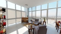 Located at 14641 Blythe St in Los Angeles, this single-floor unit sits within a high-rise building in the Panorama City neighborhood, offering a sleek, modern aesthetic throughout. The standout feature of the living area is the expansive floor-to-ceiling glass curtain wall, which floods the space with abundant natural light and frames sweeping panoramic views of the Los Angeles skyline and surrounding cityscape. The open-concept layout seamlessly connects the living and dining areas, with polished concrete-style flooring that runs consistently throughout, lending a clean, contemporary feel.

The kitchen is outfitted with light wood-grain cabinetry extending to the ceiling, white countertops, and stainless steel appliances including a range, microwave, and dishwasher. Recessed lighting above ensures a bright, functional workspace. A narrow hallway with clean white walls and soft carpeting connects the main living areas to the private spaces. The bathroom features a full soaking tub with a sliding glass enclosure, white subway tile surround, and bright, minimalist finishes. Overall, the space delivers a bright, urban living experience with modern finishes and impressive elevated views.
