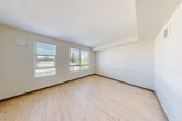 Located at 16224 Meadow Rd in Lynnwood, WA, this well-designed one-bedroom, one-bathroom unit offers a thoughtful layout across a single floor. Light-toned hardwood-style flooring runs throughout the main living areas, creating a clean and cohesive aesthetic complemented by neutral walls and warm-toned trim details.

The welcoming entrance leads into a functional layout that includes a kitchen positioned along the corridor, fitted with modern cabinetry and appliances. The living room is generously windowed, allowing abundant natural light to fill the space while framing views of the surrounding Pacific Northwest greenery. Two closets provide practical storage solutions throughout the unit.

The bedroom is a well-proportioned private retreat featuring soft carpet flooring, a ceiling fan, and a window that draws in natural light. The combined bathroom and laundry room is clean and modern, equipped with a full tub-shower surround finished in white tile, a single-basin vanity with dark wood cabinetry, and chrome fixtures. The inclusion of in-unit laundry adds a layer of everyday convenience.

Overall, the unit presents a fresh, contemporary feel with consistent finishes, efficient use of space, and a bright atmosphere enhanced by multiple windows throughout.