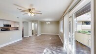 Located at 2 Hollandale Ln in Clifton Park, NY, this well-appointed 2-bedroom, 2-bathroom single-floor home offers a thoughtfully designed layout with a clean, modern aesthetic throughout. Light-toned luxury vinyl plank flooring runs seamlessly through the main living areas and bedrooms, lending a cohesive and contemporary feel.

The open-concept living room is bright and airy, featuring a ceiling fan with light fixture, a sliding glass door leading to an outdoor area, and an additional window that together flood the space with natural light. A chandelier-lit dining area transitions smoothly into the kitchen, which is equipped with white cabinetry, stainless steel appliances including a refrigerator, range, microwave, and dishwasher, complemented by a tile backsplash and a pass-through counter connecting to the living area.

The generously sized primary bedroom includes a ceiling fan, a sliding closet, and a window with outdoor views. The second bedroom also features a ceiling fan and its own window, offering a comfortable and private retreat. Both bathrooms are finished in a neutral palette with clean, functional fixtures. Throughout the home, six closets provide exceptional storage, while two hallways ensure a practical and well-connected floor plan. Neutral taupe walls and white trim complete the polished interior.