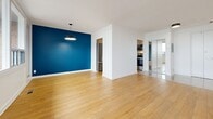 Located at 25 Woodridge Cres in Ottawa's K2B neighbourhood, this 1-bedroom, 1-bathroom unit offers a thoughtfully designed layout across a single floor. Warm hardwood flooring flows consistently throughout the space, creating a cohesive and inviting atmosphere.

The open-concept kitchen and living area forms the heart of the unit. The kitchen is equipped with light maple cabinetry, white countertops, a grey subway tile backsplash, and stainless steel appliances including a refrigerator, dishwasher, and range. The living area features a bold blue accent wall and a pendant light fixture, adding a modern, stylish touch. A bank of large windows fills the room with natural light and offers expansive outdoor views.

The bedroom is a comfortable, well-proportioned room with soft sage-green walls, a sliding mirrored closet, and a window that frames scenic views. The mirrored closet enhances the sense of space and adds a functional storage element.

The bathroom is finished with a clean, contemporary aesthetic, featuring a white vanity with undermount sink, white quartz countertop, brushed nickel hardware, and a large framed mirror.

A hallway connects the rooms efficiently, completing this well-organized and modern unit ideal for those seeking comfortable city living in Ottawa.