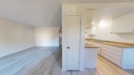 Located at 10780 Coloma Rd in Rancho Cordova, California, this 2-bedroom unit is spread across a single floor and presents a clean, modern aesthetic throughout. Light wood-style flooring flows consistently across the living areas and bedrooms, creating a cohesive and bright atmosphere.

The open living area features vaulted ceilings that add a sense of spaciousness, and the layout connects seamlessly to the kitchen. The kitchen is outfitted with white cabinetry, granite-style countertops, a built-in cooktop, and a sink with ample counter space, offering a functional and attractive workspace.

Adjacent to the kitchen, a dining area benefits from natural light streaming through a large sliding window, complemented by a ceiling fan for added comfort. A closet door in the central hallway provides convenient storage access.

Both bedrooms are well-proportioned and feature sliding mirrored closet doors that maximize storage while reflecting light to enhance the sense of space. The rooms maintain the same light flooring found throughout the unit and offer a neutral palette ideal for personalization.

The bathroom includes a full tub and shower combination with modern brushed nickel fixtures set against clean white surroundings, maintaining the unit's consistent, well-maintained presentation. Overall, this unit delivers a tidy and functional living environment.
