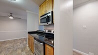 This single-floor residence in Walnut Creek, California, offers a thoughtfully designed layout that balances comfort and functionality. The open-concept living area features a seamless transition between carpeted and wood-look flooring, with crown molding adding a refined architectural detail. A wall-mounted mini-split unit provides climate control, while a sliding glass door opens to a private balcony overlooking lush, tree-lined surroundings, filling the space with natural light.

The kitchen is efficiently designed with warm honey-toned cabinetry, sleek dark countertops, and a full suite of stainless steel appliances, including an electric range, over-the-range microwave, refrigerator, and dishwasher. A dedicated in-unit laundry area with a stacked washer and dryer adds everyday convenience.

The bedrooms are carpeted for comfort, each featuring large windows that frame greenery views. One bedroom includes a generous closet with double hanging rods. The bathroom is clean and functional, with matching cabinetry, dark countertops, and a tub/shower combination. Throughout the residence, a neutral gray palette and consistent finishes create a cohesive, move-in-ready ambiance.