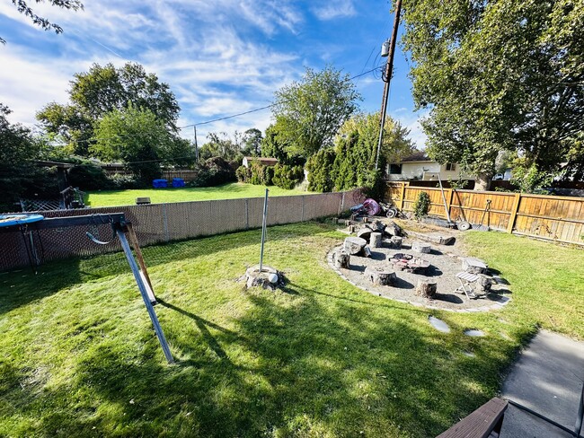 Backyard view with fire pit and garden area - 219 Thayer Dr