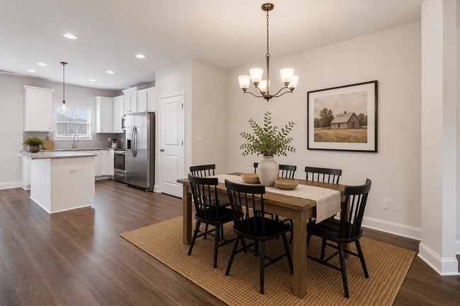 Elegant dining room featuring a rich wooden table and timeless seating—designed for unforgettable family gatherings. - Surrey Green