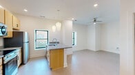 This 590 square foot apartment in Newport News, VA, offers a thoughtful layout that maximizes space efficiency. The single-floor design features one bedroom measuring 130 square feet, providing ample space for rest and relaxation. The open-concept living area seamlessly integrates the kitchen and living room, creating a sense of spaciousness.

The kitchen boasts modern amenities, including light wood cabinetry, stainless steel appliances, and a granite countertop. Pendant lighting adds a touch of style while illuminating the cooking and dining areas. The living room, adjacent to the kitchen, offers flexibility for furniture arrangement and includes a ceiling fan for comfort.

Throughout the apartment, neutral-toned carpeting and crisp white walls create a bright, airy atmosphere. The bathroom features a clean, white design with a tub-shower combination. Large windows in the living area and bedroom allow natural light to flood the space, enhancing the overall ambiance.

Two hallways provide easy navigation through the apartment, connecting the various rooms efficiently. The property's layout, as seen in the 3D floor plan, demonstrates a well-designed use of space, ensuring each area serves a distinct purpose while maintaining an open feel. This apartment is ideal for singles or couples seeking a modern, low-maintenance living space in a convenient Newport News location.