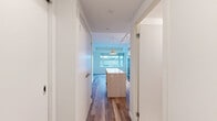 Located at 55 Quebec Ave in Toronto's vibrant Junction neighbourhood, this efficiently designed studio unit offers a thoughtfully arranged single-floor layout comprising a kitchen, bathroom, and open living area. The kitchen is a standout feature, showcasing contemporary flat-panel cabinetry in soft grey and white tones, stainless steel appliances including a full-size refrigerator, electric range, and dishwasher, complemented by a crisp white countertop and a decorative patterned tile backsplash. Under-cabinet lighting and track-mounted ceiling fixtures provide a warm, functional ambiance. A peninsula counter adds extra workspace and subtly defines the kitchen from the living area. The living space features light hardwood-style flooring and a large window that frames views of the surrounding urban landscape, allowing natural light to fill the room. The bathroom is finished with large-format porcelain floor tiles, warm wood-toned wall tiles in the tub surround, a clean white vanity with an undermount sink, and a bathtub-shower combination. Neutral tones throughout the unit create a cohesive, modern aesthetic, making this a well-appointed urban residence ideal for those seeking a functional and stylish living space in the heart of Toronto.