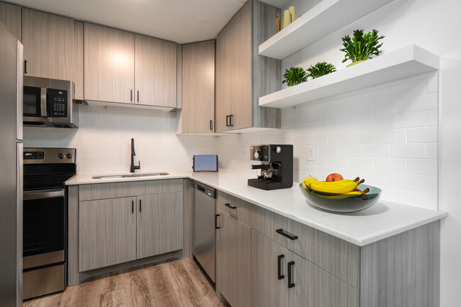 Floating shelves and ceramic tile backsplash in kitchen - InHabit Apartments