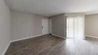 Located at 2300 Sherry Circle in Milledgeville, Georgia, this single-floor, 2-bedroom, 3-bathroom home offers a practical and comfortable layout with neutral tones throughout. The open living area features durable hardwood-style flooring and a textured ceiling, with natural light filtering in through windows that brighten the connected spaces. The kitchen is efficiently designed with white cabinetry, granite-look countertops, a double stainless steel sink with a brushed nickel faucet, and full appliances including a refrigerator and dishwasher. Both bedrooms are carpeted and fitted with ceiling fans with integrated lighting, providing a cozy atmosphere. The generously sized primary bedroom includes closet access and connects to the broader hallway layout. The bathrooms feature clean, white tub-shower combinations with built-in shelving niches, offering functional and low-maintenance design. A hallway with light hardwood-style flooring connects the rooms, creating a smooth flow throughout the home. Consistent neutral wall colors, white trim, and textured ceilings lend a cohesive, understated aesthetic to every room in this well-organized Milledgeville residence.