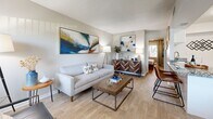 Located at 1699 68th St N in Saint Petersburg, Florida, this one-bedroom, one-bathroom residence offers a thoughtfully designed single-floor layout that maximizes every square foot. Light wood-style flooring runs throughout, lending a cohesive and modern feel to the entire unit.

The combined kitchen and living area forms the heart of the home. The kitchen features granite countertops, white cabinetry, stainless steel appliances including a full-size refrigerator, and a convenient in-unit washer — a practical amenity that adds everyday ease. The living room is bright and welcoming, with a large window fitted with vertical blinds that allow natural light to fill the space. A textured ceiling adds subtle architectural character overhead.

The bedroom is a comfortable retreat, offering a ceiling fan with light fixture, a double-door closet, and a window with decorative curtains that invite natural light. The room accommodates a full-size bed with ease, reflecting smart use of the available space.

The bathroom is clean and well-appointed, featuring a granite-topped vanity with white cabinetry, a tub-shower combination with a curtain, and light wood-style flooring that ties the space together. The all-white palette creates a bright, fresh atmosphere throughout.