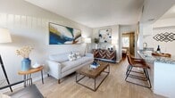 Located at 1699 68th St N in Saint Petersburg, Florida, this one-bedroom, one-bathroom residence offers a thoughtfully designed single-floor layout that maximizes every square foot. Light wood-style flooring runs throughout, lending a cohesive and modern feel to the entire unit.

The combined kitchen and living area forms the heart of the home. The kitchen features granite countertops, white cabinetry, stainless steel appliances including a full-size refrigerator, and a convenient in-unit washer — a practical amenity that adds everyday ease. The living room is bright and welcoming, with a large window fitted with vertical blinds that allow natural light to fill the space. A textured ceiling adds subtle architectural character overhead.

The bedroom is a comfortable retreat, offering a ceiling fan with light fixture, a double-door closet, and a window with decorative curtains that invite natural light. The room accommodates a full-size bed with ease, reflecting smart use of the available space.

The bathroom is clean and well-appointed, featuring a granite-topped vanity with white cabinetry, a tub-shower combination with a curtain, and light wood-style flooring that ties the space together. The all-white palette creates a bright, fresh atmosphere throughout.