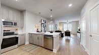 Located at 60 Chocktawhatchee Way in Santa Rosa Beach, FL, this well-appointed three-bedroom, two-bathroom residence offers a thoughtfully designed single-floor layout with contemporary finishes throughout. The open-concept kitchen and living area serves as the heart of the home, where a central island with a stainless steel dishwasher and crisp white quartz countertops anchors the space. Light gray wood-grain cabinetry, a classic subway tile backsplash, and stainless steel appliances complete the kitchen. Pendant lighting overhead transitions seamlessly into the living room, which features light wood-style flooring, large windows with outdoor views, and a ceiling fan. A welcoming entryway with a console area adds a functional yet stylish touch near the front door. The primary bedroom is a comfortable retreat with plush carpeting, natural light from large windows, and access to a well-sized en-suite bathroom featuring a dual-sink vanity with quartz countertops and a glass-enclosed walk-in shower with white subway tile. A spacious walk-in closet with built-in shelving provides ample storage. The additional bedrooms also feature carpeted floors and generous natural light. Two dedicated closets across the home ensure practical storage throughout this clean, modern residence.