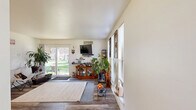 This well-appointed 1-bedroom, 2-bathroom unit at 1900 Laurel Rd in Lindenwold, NJ offers a practical and comfortable single-floor layout. The living room is the heart of the home, featuring hardwood-style flooring, multiple windows that flood the space with natural light, and sliding glass doors that open to a lush green outdoor area — a standout feature that seamlessly connects interior and exterior living. A dedicated office provides a versatile secondary space with its own window and mirrored closet doors, making it ideal for working from home or use as a flex room. The bedroom is generously sized, accommodating a large bed with ease, and includes a window with outdoor views, wood-style flooring, and direct access to a bathroom. The two bathrooms offer distinct configurations: one features a clean, modern vanity with a stone-topped countertop and ample mirror space, while the second includes a full tub-shower combination with tile accents. The galley-style kitchen is efficiently designed with warm wood cabinetry extending to ceiling height, a gas range, dishwasher, and light tile flooring. Throughout the unit, neutral tones and consistent flooring create a cohesive and inviting atmosphere.