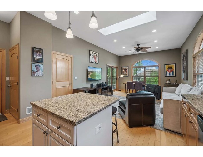 View from kitchen of living room, dining room. Note skylight and plentiful natural light throughout! - 3125 Inglewood Ave S