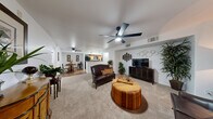 Located at 3250 S Town Center Dr in Las Vegas, NV, this 2-bedroom, 2-bathroom residence offers a thoughtfully designed single-floor layout. The open living room features plush carpeting, a ceiling fan with light fixture, and a defined media wall with an arched accent, creating a comfortable and inviting atmosphere. The space flows seamlessly into the combined dining room and kitchen area, where warm hardwood-style flooring, rich wood cabinetry, granite-style countertops, and black appliances — including a range, microwave, refrigerator, and dishwasher — come together in a functional galley-style arrangement. A ceiling fan with a skylight above adds brightness to the kitchen and dining area. The generously sized primary bedroom offers carpeted floors, a ceiling fan, and a walk-in closet with wire shelving. The second bedroom is equally well-appointed with a ceiling fan and natural light from a window. Both bathrooms are finished with wood cabinetry and include a shower with tile surround and hardwood-style flooring. A dedicated in-unit laundry area with washer and dryer adds everyday convenience. Two closets provide ample storage throughout the residence, completing this well-rounded Las Vegas home.