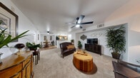 Located at 3250 S Town Center Dr in Las Vegas, NV, this 2-bedroom, 2-bathroom residence offers a thoughtfully designed single-floor layout. The open living room features plush carpeting, a ceiling fan with light fixture, and a defined media wall with an arched accent, creating a comfortable and inviting atmosphere. The space flows seamlessly into the combined dining room and kitchen area, where warm hardwood-style flooring, rich wood cabinetry, granite-style countertops, and black appliances — including a range, microwave, refrigerator, and dishwasher — come together in a functional galley-style arrangement. A ceiling fan with a skylight above adds brightness to the kitchen and dining area. The generously sized primary bedroom offers carpeted floors, a ceiling fan, and a walk-in closet with wire shelving. The second bedroom is equally well-appointed with a ceiling fan and natural light from a window. Both bathrooms are finished with wood cabinetry and include a shower with tile surround and hardwood-style flooring. A dedicated in-unit laundry area with washer and dryer adds everyday convenience. Two closets provide ample storage throughout the residence, completing this well-rounded Las Vegas home.