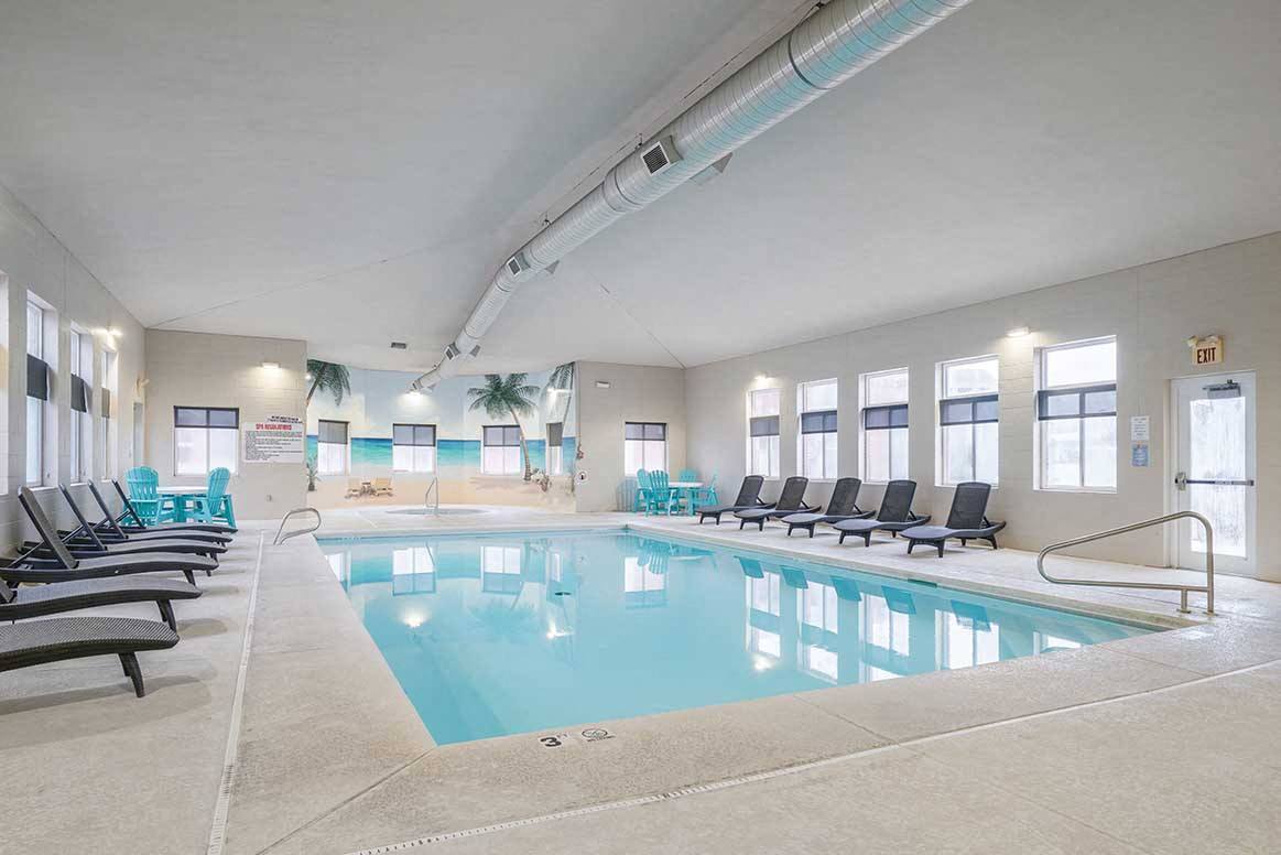 Our clubhouse includes an indoor clubhouse for year-round swimming. - Cascade Pines Duplexes