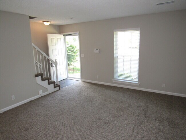 Building Photo - Townhome unit with renovations, trash/lawn...