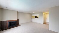 Located at 3030 Pebble Point Dr in Indianapolis, IN, this two-bedroom, two-bathroom residence offers a well-organized single-floor layout designed for comfortable everyday living. The open living room is a standout space, featuring soft carpeting, recessed lighting, and a tile-surround wood-burning fireplace that serves as a focal point. A pass-through counter connects the living area to the kitchen, enhancing the open feel while maintaining a defined cooking space. The kitchen is efficiently designed with light-colored cabinetry, ample counter space, a double basin sink, and black appliances including an electric range and refrigerator, all set on durable wood-look flooring. Both bedrooms are carpeted and neutral in tone, offering a calm and restful atmosphere. The primary bedroom benefits from a large window with outdoor views and features two closets, including a walk-in, providing generous storage. Each bathroom is equipped with a full tub and shower combination, maintaining a clean, functional design. Additional closet space throughout the unit adds to its practicality. The overall aesthetic is understated and move-in ready, with a consistent neutral color palette that lends itself well to a variety of furnishing styles.