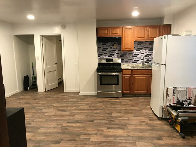 Standing in living room facing kitchen. On left is laundry hookup and bedroom #1. - 31 Sand Creek Rd