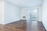 Located at 4701 Sheboygan Ave in Madison, WI, this 2-bedroom, 1-bathroom unit offers a practical and well-appointed single-floor layout. The living room serves as the central gathering space, featuring rich hardwood-style flooring, clean white walls, and a large sliding glass door that invites natural light and provides views of the outdoor greenery. Baseboard heating and a wall-mounted AC unit ensure year-round comfort throughout the space.

The kitchen connects seamlessly to the living area and is equipped with standard appliances, cabinetry, and a functional layout ideal for everyday use. A connecting hallway links the main living areas to the bedrooms and bathroom.

The generously sized primary bedroom features soft carpeting, a natural light-filled window with blinds, baseboard heating, and a spacious double closet with bi-fold doors and built-in shelving for ample storage. The second bedroom mirrors this comfortable design with carpet flooring, a bright window, and baseboard heating.

The full bathroom is finished in a clean, neutral palette with a white vanity and countertop, a large mirror, brushed nickel fixtures, and a tub-shower combination with tile surround. Hardwood-style flooring ties the bathroom's aesthetic to the rest of the unit, creating a cohesive look throughout the home.
