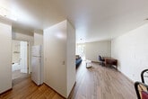 Located at 121 E Hoover in Ann Arbor, MI, this one-bedroom, one-bathroom unit offers a practical and efficient layout across a single floor. Wood-look plank flooring runs throughout the space, providing a cohesive and easy-to-maintain surface underfoot.

The open living and dining area serves as the heart of the unit, featuring painted concrete block walls that lend an understated, utilitarian character. A large window floods the space with natural light and offers views of the surrounding neighborhood. A ceiling fan overhead provides air circulation. This area comfortably accommodates both a seating arrangement and a dining table, making it versatile for everyday living.

The kitchen is positioned adjacent to the living area, separated by a partial wall. It includes a full-size refrigerator and essential appliances, offering a functional cooking space. Three closets throughout the unit provide generous storage options relative to the overall footprint.

The bedroom is a well-proportioned room with a window that brings in natural light and greenery views from outside, continuing the wood-look flooring found throughout.

The bathroom features a full bathtub and shower combination with classic cream-toned tile surround, keeping the space clean and straightforward. Overall, this unit delivers a functional and no-frills living environment well-suited for individuals seeking a practical home in Ann Arbor.
