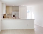 This contemporary single-story residence in Montgomery, TX offers a well-designed living space of 1,330 square feet. The home features three bedrooms, including a generous 200 square foot primary bedroom, and two full bathrooms. The open-concept layout seamlessly combines the kitchen and living room, creating a spacious and inviting atmosphere.

The kitchen is a highlight, boasting pristine white cabinetry, sleek countertops, and stainless steel appliances, including a built-in microwave and refrigerator. The living area is bright and airy, with large windows allowing natural light to flood the space. Light-colored flooring throughout enhances the sense of openness.

Each bedroom is well-proportioned, with the primary bedroom offering ample space and an en-suite bathroom. The bathrooms feature modern fixtures, including a walk-in shower in at least one. The home also includes a dedicated laundry room and multiple closets for storage, including walk-in options in some bedrooms.

Additional features include ceiling fans for improved air circulation, window blinds for privacy, and recessed lighting. The neutral color palette and clean lines contribute to the home's modern aesthetic, providing a blank canvas for various decorating styles.