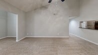 Located at 3250 Mercer University Dr in Chamblee, GA, this single-floor residence offers 2 bedrooms and 3 bathrooms in a thoughtfully laid-out floor plan. The living room serves as the heart of the home, showcasing a vaulted ceiling with a ceiling fan, plush carpeting, a tile-surround fireplace, and a window that brings in natural light and greenery views. An adjacent kitchen/living area features warm hardwood-style flooring, white cabinetry with dark countertops, and a full suite of stainless steel appliances, including a refrigerator, range, and built-in microwave. A peninsula provides convenient counter seating and separates the kitchen from the dining area. The primary bedroom is a well-proportioned retreat with carpet flooring, a mirrored sliding-door closet, and a window overlooking lush outdoor scenery. The second bedroom is similarly carpeted and naturally lit, with ample wall space. Three bathrooms offer functionality and convenience throughout, each featuring tub-shower combinations with white tile surrounds. A dedicated laundry room and a hallway closet add practical storage and everyday convenience to this comfortable Chamblee residence.