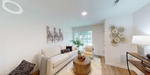 This thoughtfully designed 480-square-foot, one-bedroom, one-bathroom apartment at 277 N Rose St, Unit 101 in Mount Clemens, Michigan, offers an efficient and modern living experience across a single floor. The open-concept layout maximizes the use of space, seamlessly connecting the living room, kitchen, and dining area. The living room is bright and inviting, featuring light wood flooring, large sliding glass doors that allow abundant natural light and outdoor views, and clean white walls that enhance the airy atmosphere. The kitchen is well-appointed with white shaker cabinetry accented by gold hardware, stainless steel appliances including a range, over-the-range microwave, and refrigerator, complemented by white countertops and matching wood flooring. The 120-square-foot bedroom provides a comfortable retreat, featuring a window for natural light and warm hardwood-style flooring. The bathroom is finished with elegant marble-style tile flooring, a white vanity with a quartz countertop, and a shower-tub combination. A dedicated closet provides practical storage. The entryway includes a smart lock on the front door and additional overhead cabinetry. The unit's clean, neutral palette and modern finishes create a cohesive and functional living environment.