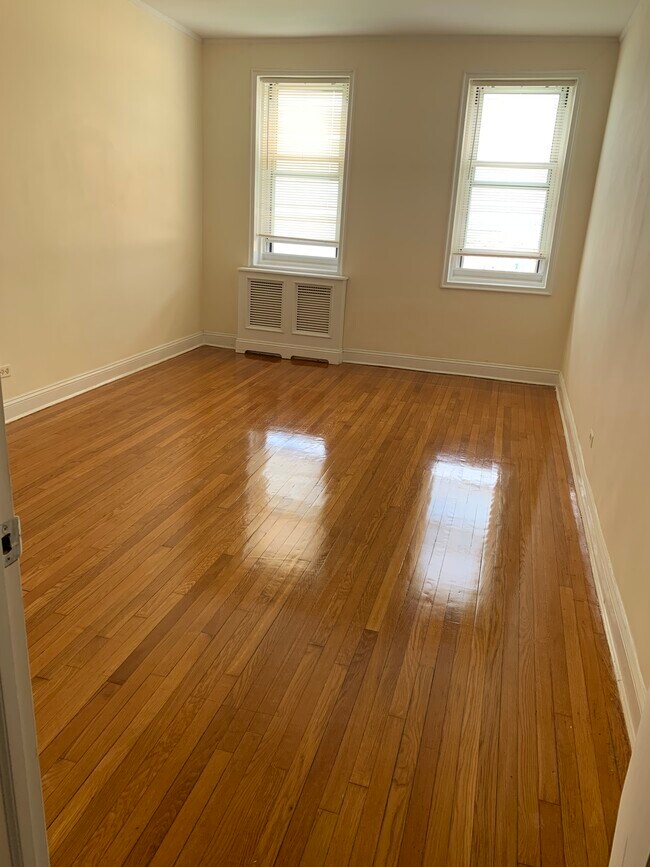 Bedroom with redone hardwood floors and custom radiator cover - 286 Corbin Plz
