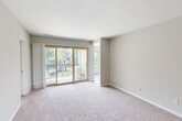 Located at 14175 Castle Blvd in Silver Spring, Maryland, this well-appointed 3-bedroom, 2-bathroom unit offers a comfortable and functional layout across a single floor. The galley-style kitchen is a standout feature, showcasing white shaker cabinetry, dark granite countertops, a subway tile backsplash, stainless steel gas range, and wood-look flooring — all bathed in natural light from a window overlooking lush greenery. The kitchen opens toward the dining area, creating an easy flow for entertaining. The spacious living room is carpeted and features sliding glass doors leading to a private balcony with peaceful wooded views, filling the space with natural light. Each of the three bedrooms is carpeted and features neutral gray walls with windows that bring in outdoor views, creating a calm and restful atmosphere. The generously sized primary bedroom offers ample room for a full suite of furniture. Both bathrooms are finished with white vanity cabinetry, dark granite countertops, framed mirrors, and wood-look flooring, providing a clean and modern aesthetic. A hallway and dedicated closet round out the layout, adding practical storage throughout. The unit also includes a ceiling fan in the dining area for year-round comfort.